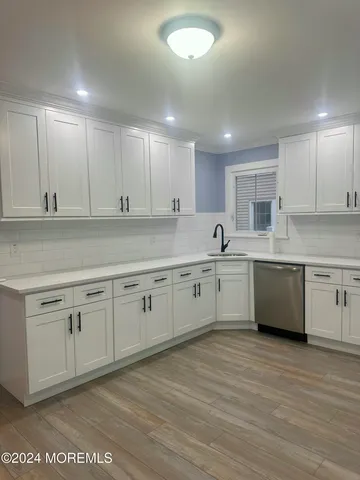 a kitchen with stainless steel appliances granite countertop a stove sink and cabinets