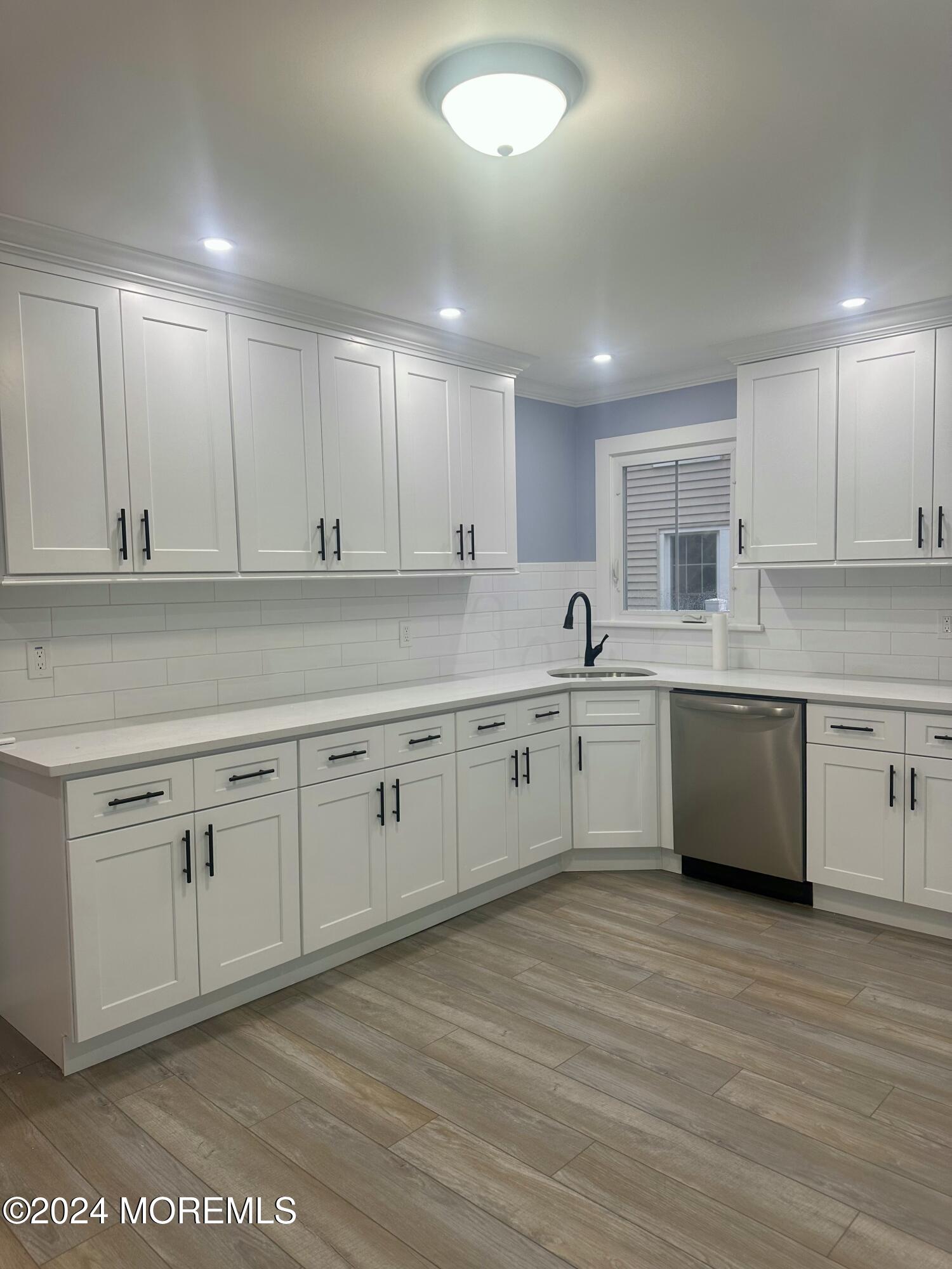 73 Church Street Manasquan, NJ 08736 - Photo 13 of 27 a kitchen with stainless steel appliances granite countertop a sink a stove and cabinets