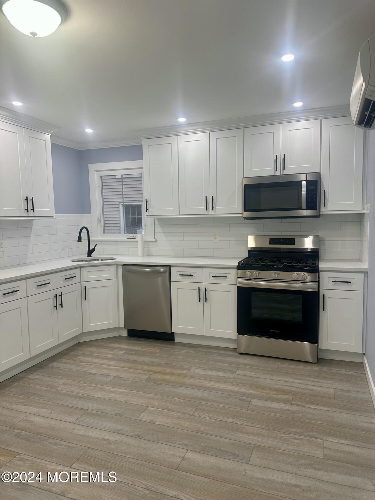 73 Church Street Manasquan, NJ 08736 - Photo 14 of 27 a kitchen with stainless steel appliances granite countertop a stove sink and cabinets