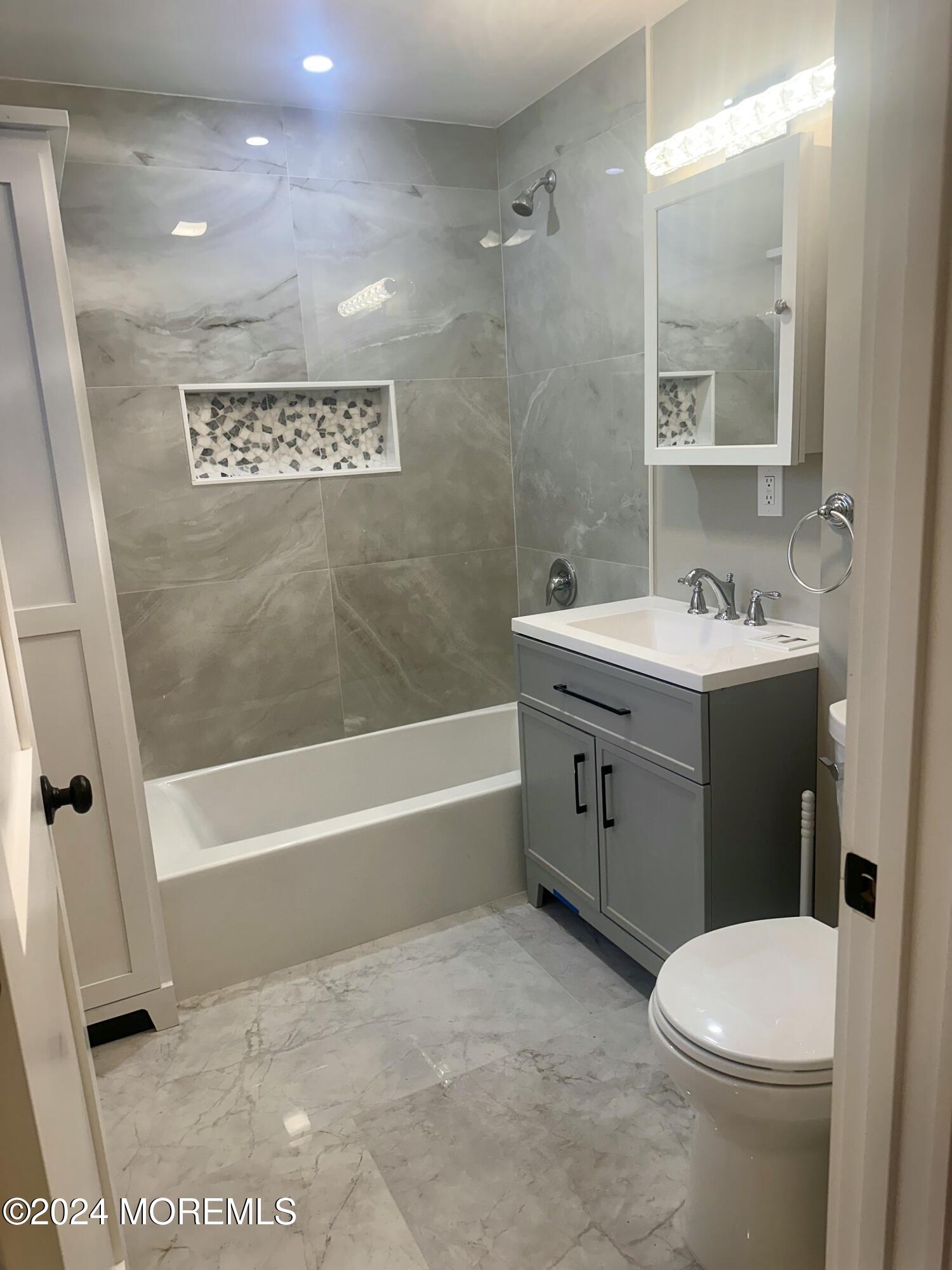 73 Church Street Manasquan, NJ 08736 - Photo 18 of 27 a bathroom with a sink a toilet and a bathtub