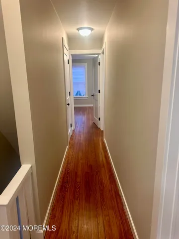 a view of an entryway with wooden floor