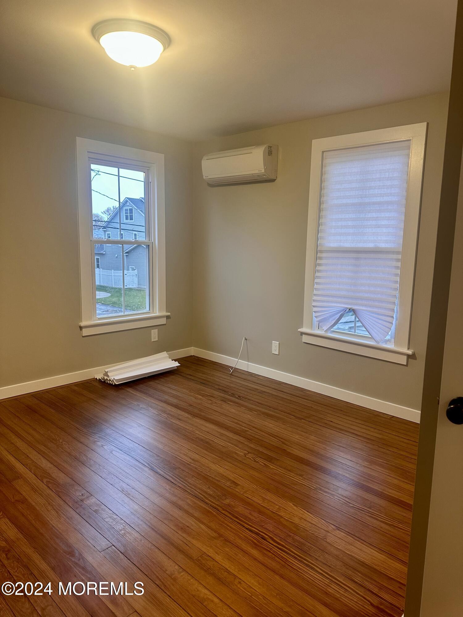 73 Church Street Manasquan, NJ 08736 - Photo 24 of 27 an empty room with wooden floor and windows