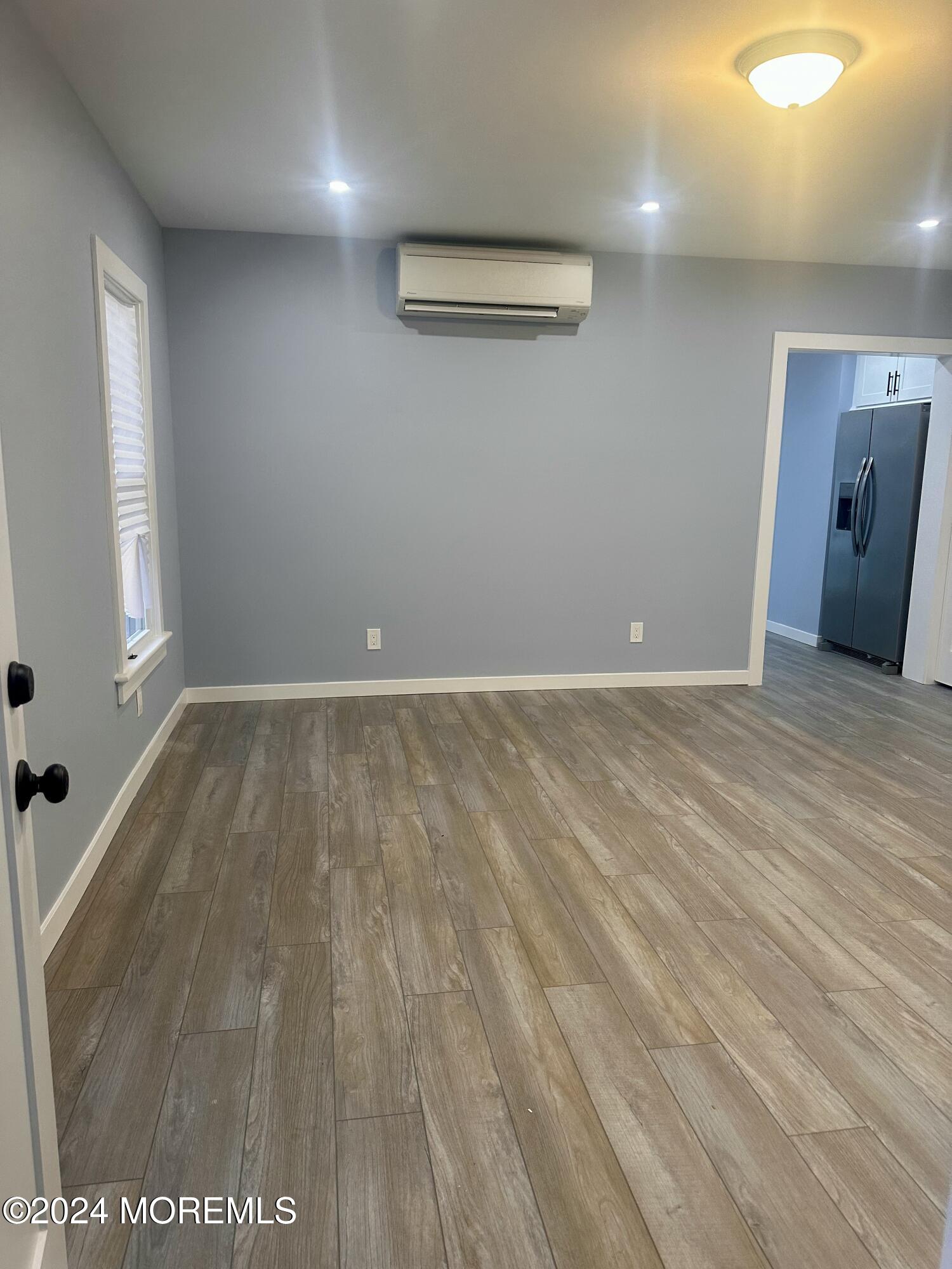 73 Church Street Manasquan, NJ 08736 - Photo 3 of 27 an empty room with wooden floor and windows