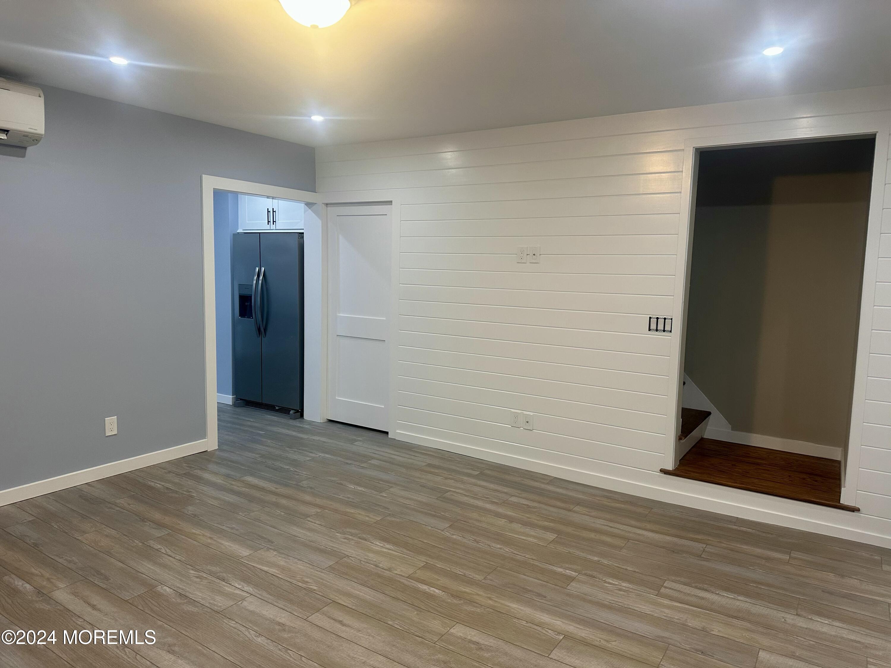 73 Church Street Manasquan, NJ 08736 - Photo 4 of 27 an empty room with wooden floor and entrance