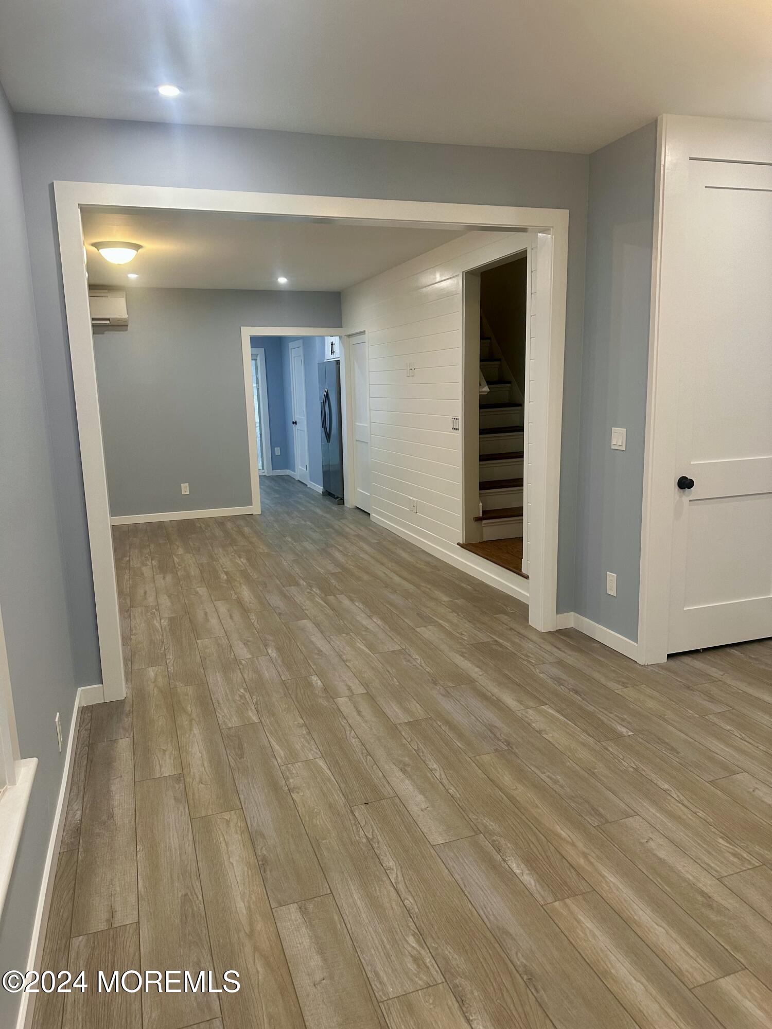73 Church Street Manasquan, NJ 08736 - Photo 10 of 27 a view of an empty room with wooden floor