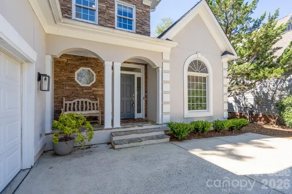 a view of a house with porch and garden