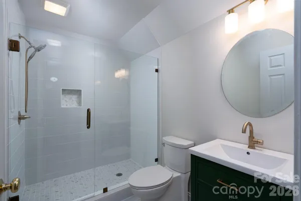 a bathroom with a sink a toilet and a mirror