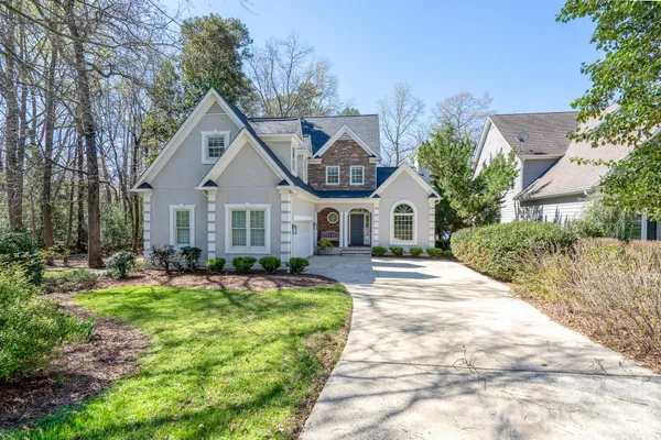 a front view of a house with a yard table and chairs