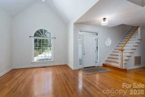 wooden floor in an empty room with a window and wooden floor