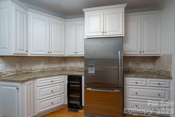 a kitchen with granite countertop cabinets and appliances