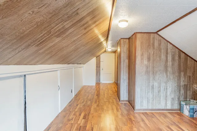 a view of a bedroom with wooden floor