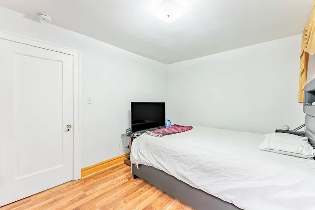 a bedroom with a bed and flat screen tv