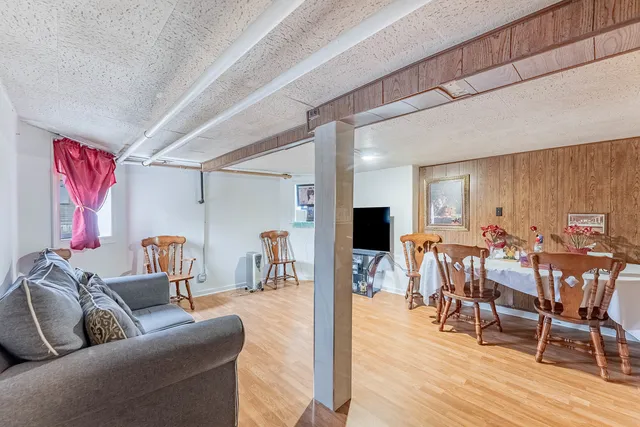 a living room with furniture dining area and a wooden floor