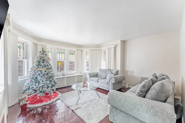 a living room with furniture and flowers