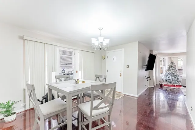 a view of a dining room with furniture and chandelier