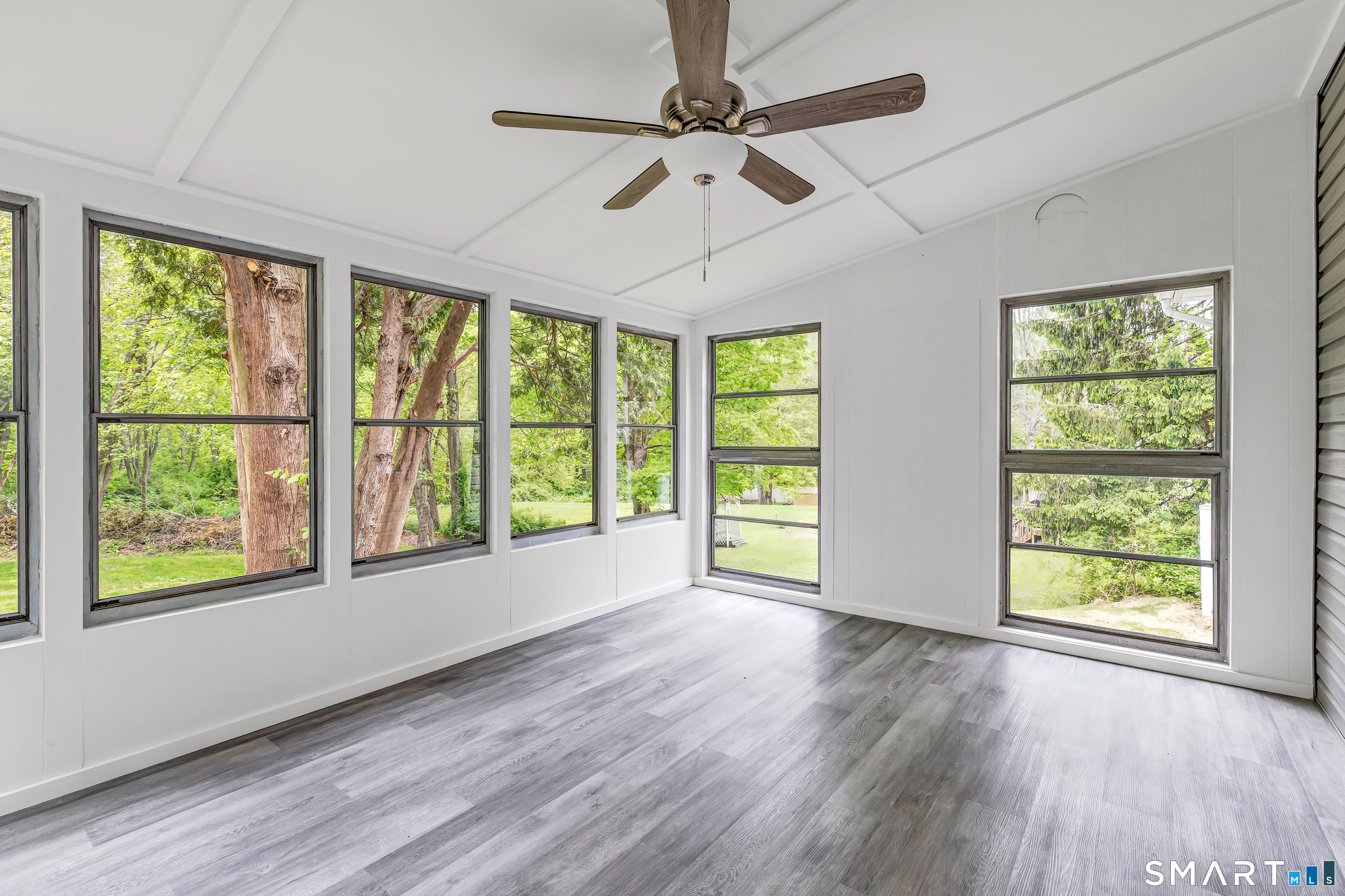 7 Longview Road Newtown, CT 06482 - Photo 27 of 40 a view of an empty room with wooden floor and a window