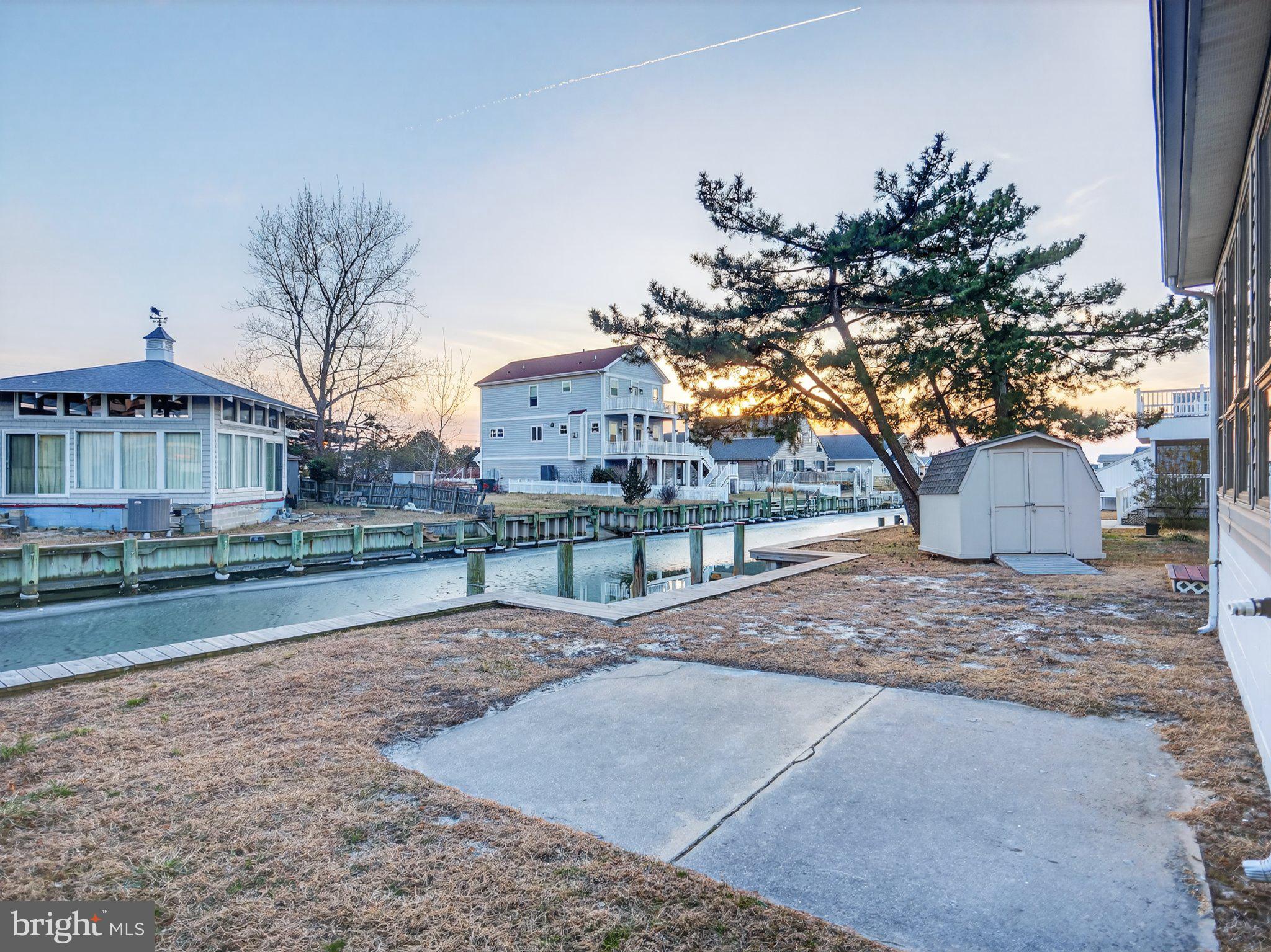 103 Channel Buoy Road Ocean City, MD 21842 - Photo 6 of 29 Serene waterfront retreat at dusk.