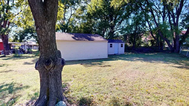 a tree in front of a white house