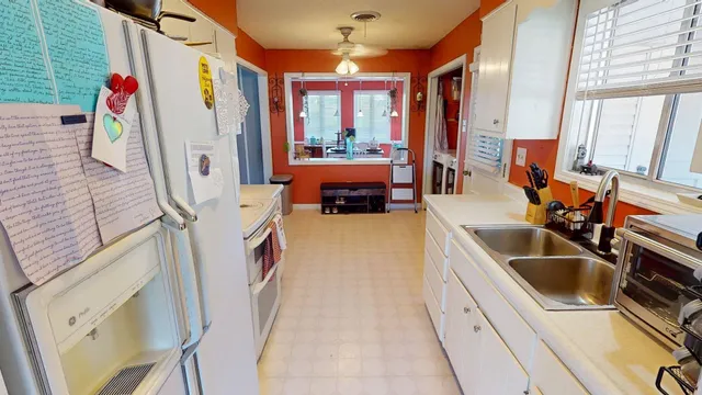 a utility room with sink dryer and washer