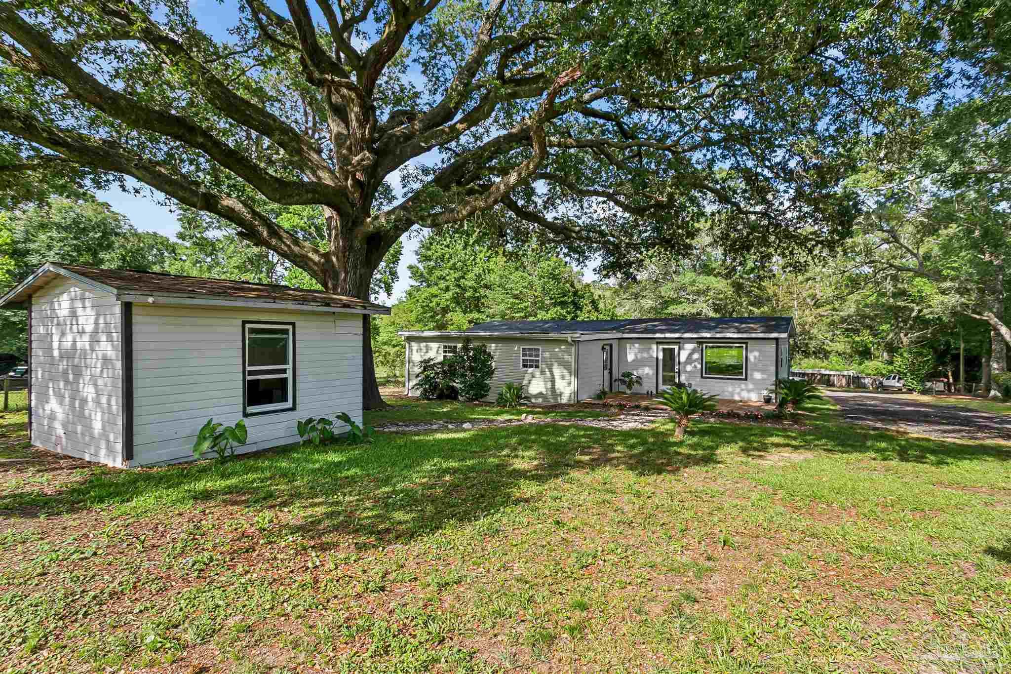 1095 River Annex Road Cantonment, FL 32533 - Photo 27 of 32 a view of a yard in front of a house with large tree