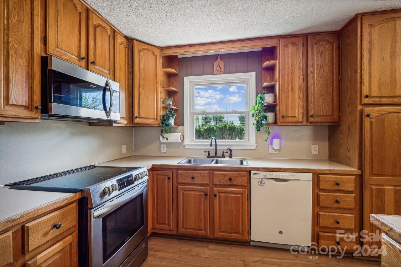 2362 Agony Acres Road Clover, SC 29710 - Photo 13 of 36 a kitchen with a sink stove and cabinets