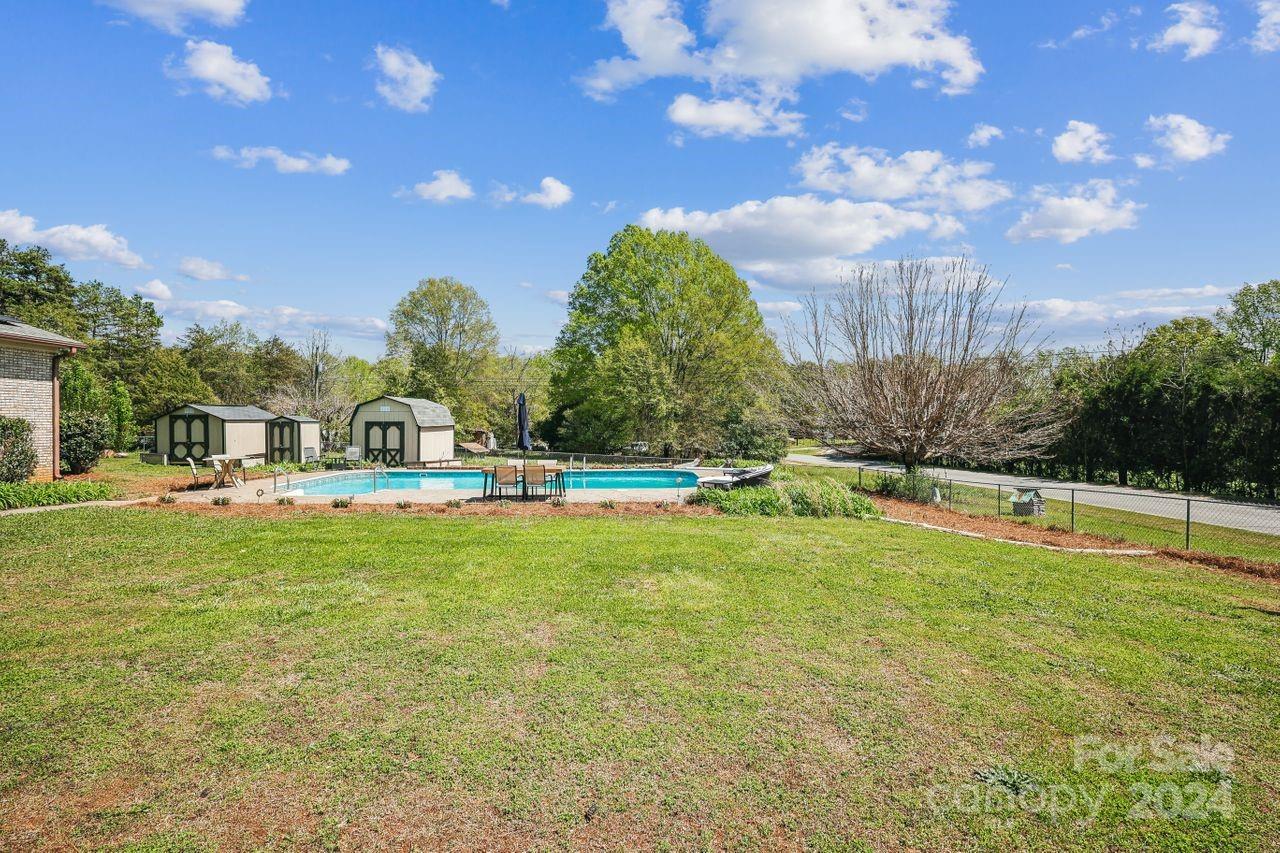 2362 Agony Acres Road Clover, SC 29710 - Photo 29 of 36 a house view with swimming pool and trees in the background