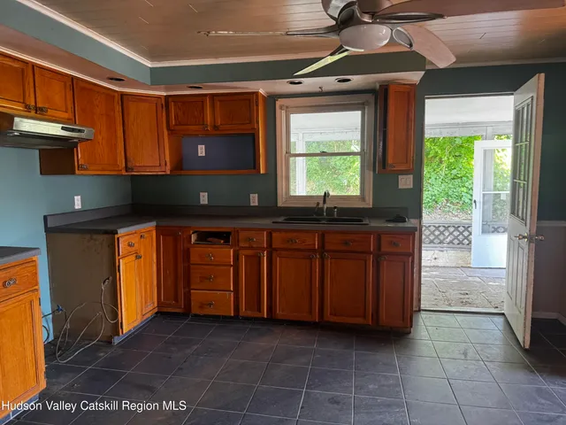a kitchen with a sink a counter top space and cabinets