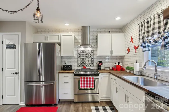 a kitchen with refrigerator and cabinets