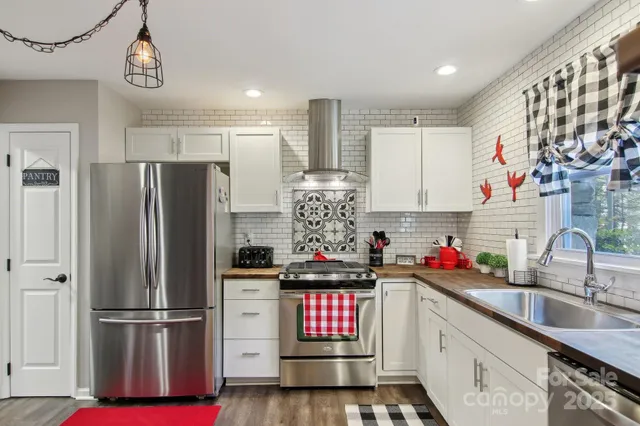 a kitchen with refrigerator and cabinets