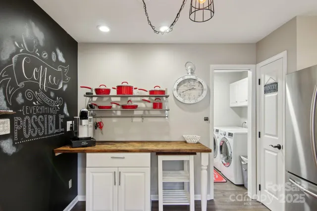a kitchen with stainless steel appliances granite countertop a sink and a refrigerator