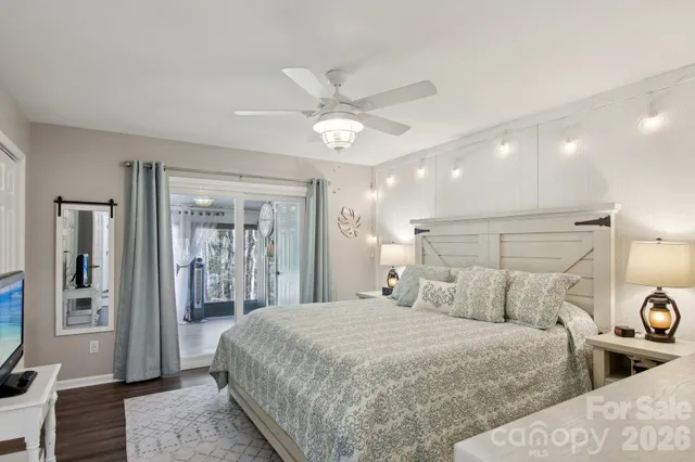 a bedroom with a large bed and a chandelier