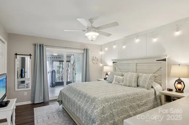 a bedroom with a large bed and a chandelier