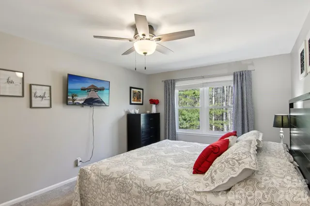 a bedroom with a bed and a chandelier