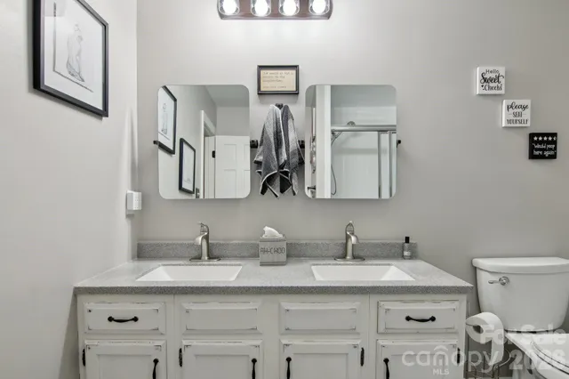 a bathroom with a sink toilet and mirror