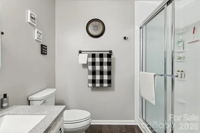 a bathroom with a toilet and a shower