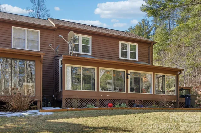 a aerial view of a house with a yard and balcony