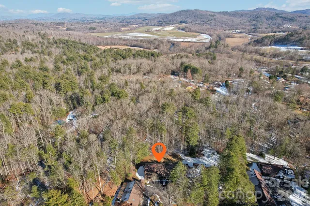 a aerial view of a house with a yard