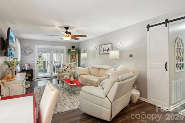 a living room with furniture and a chandelier