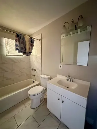 a kitchen with granite countertop a refrigerator sink and cabinets