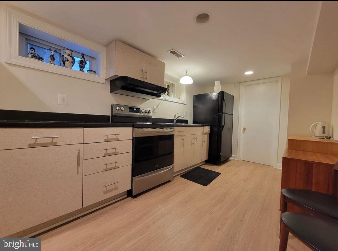 1418 44th Street Northwest, Unit B Washington, DC 20007 - Photo 20 of 20 a kitchen with stainless steel appliances granite countertop a stove a sink and a refrigerator