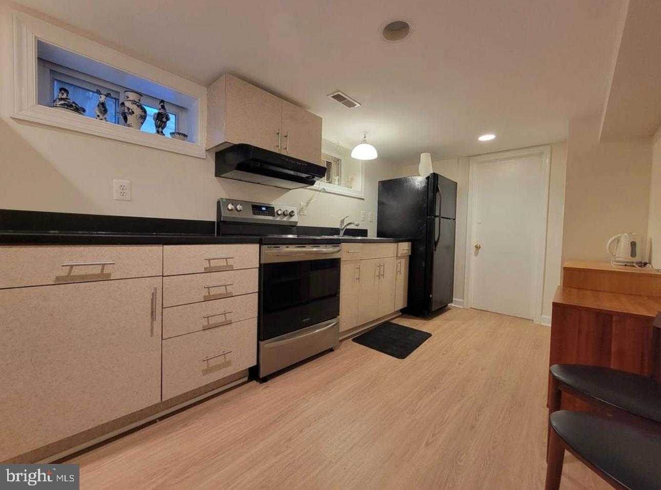 1418 44th Street Northwest, Unit B Washington, DC 20007 - Photo 4 of 20 a kitchen with stainless steel appliances granite countertop a stove a sink and a refrigerator