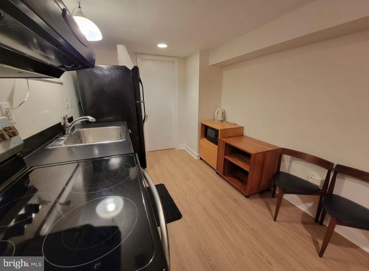 1418 44th Street Northwest, Unit B Washington, DC 20007 - Photo 5 of 20 a room with furniture and air hockey table