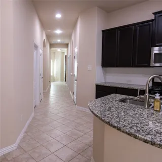 a kitchen with granite countertop sink stainless steel appliances and cabinets