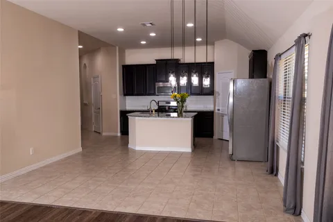 a kitchen with stainless steel appliances a refrigerator sink and microwave
