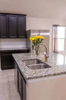 a kitchen with a granite countertop sink and a granite counter tops