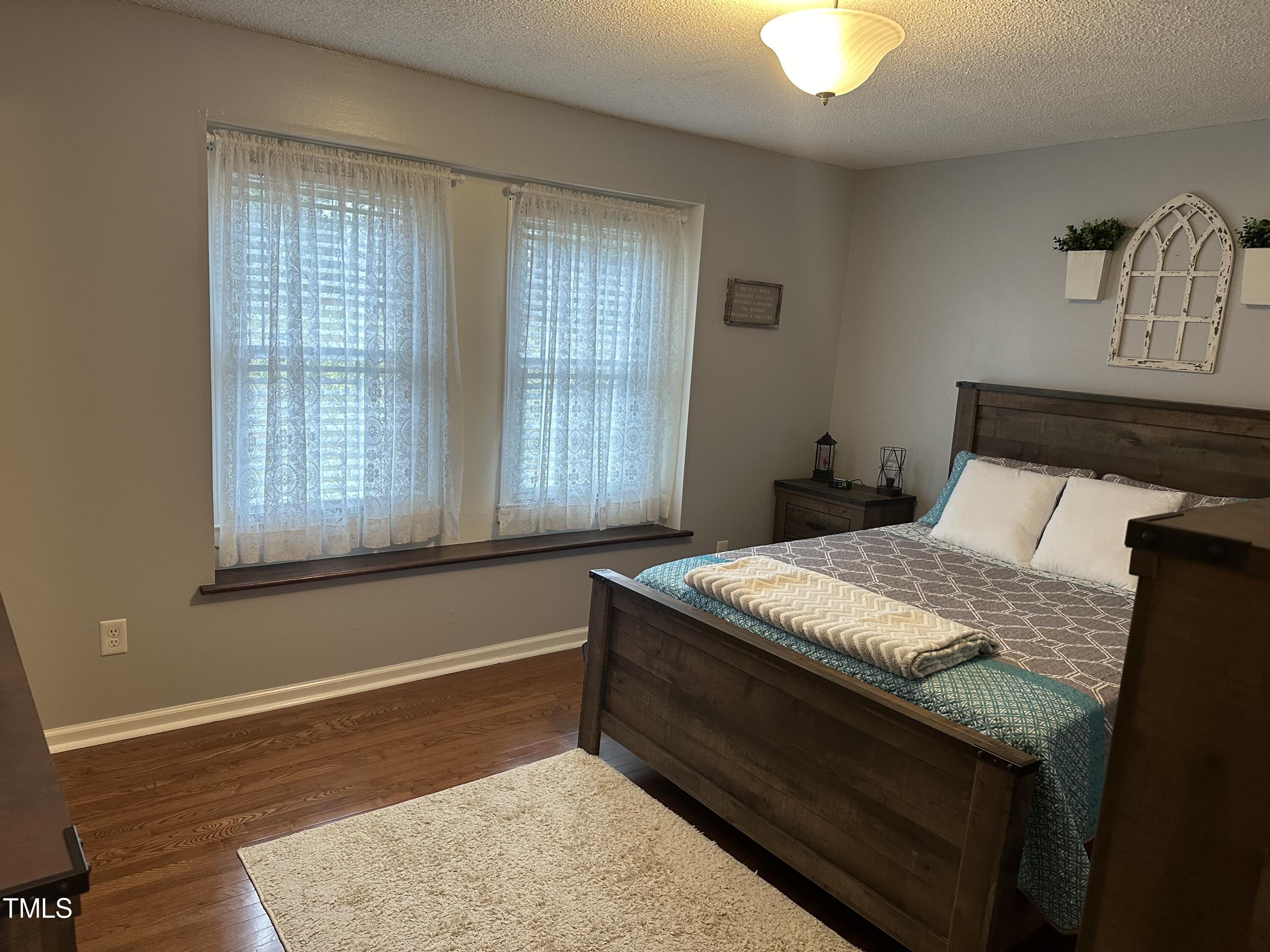 242 Edwards Road Henderson, NC 27537 - Photo 14 of 21 a bedroom with a bed and window