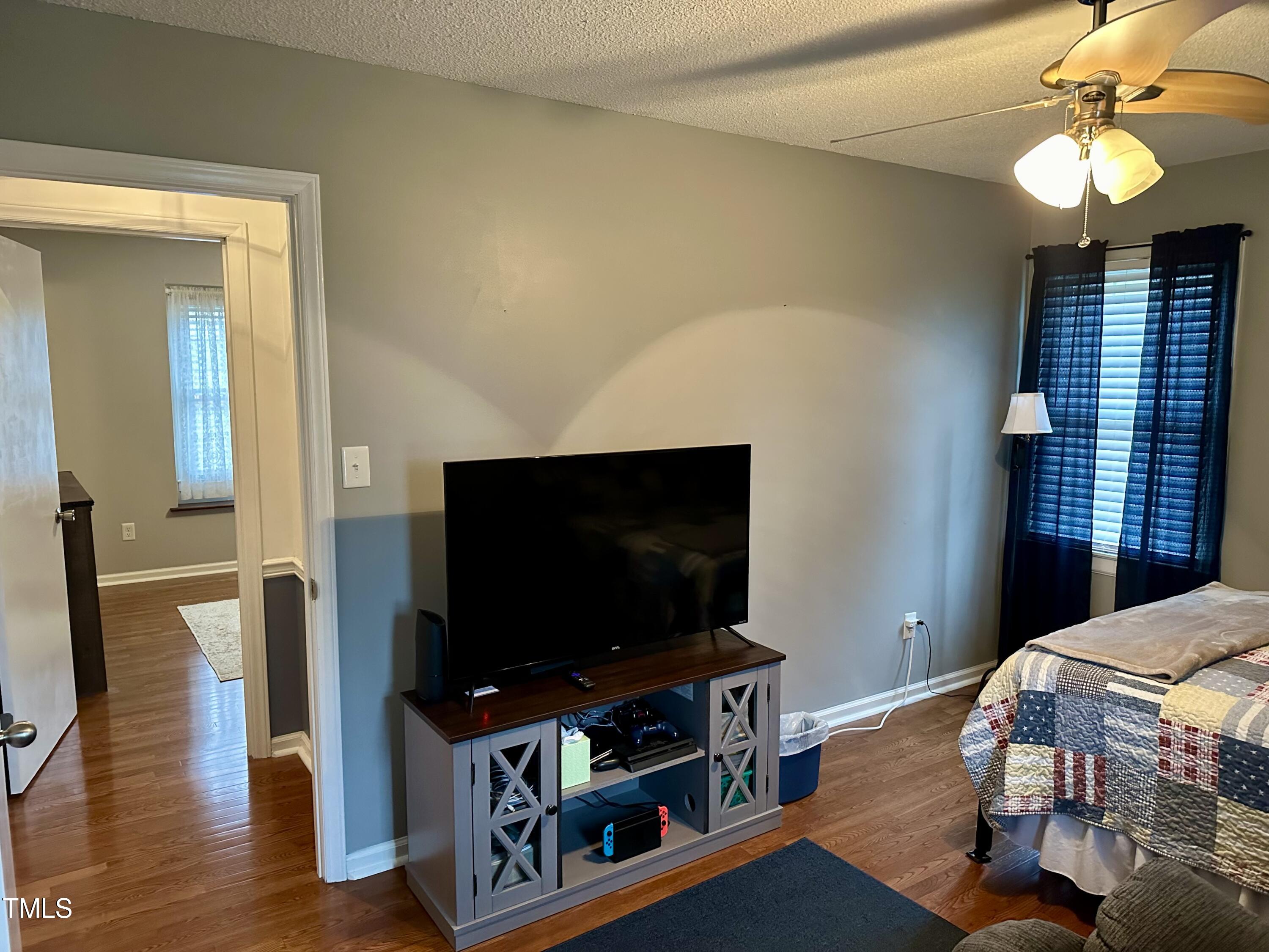 242 Edwards Road Henderson, NC 27537 - Photo 17 of 21 a living room with furniture and a flat screen tv