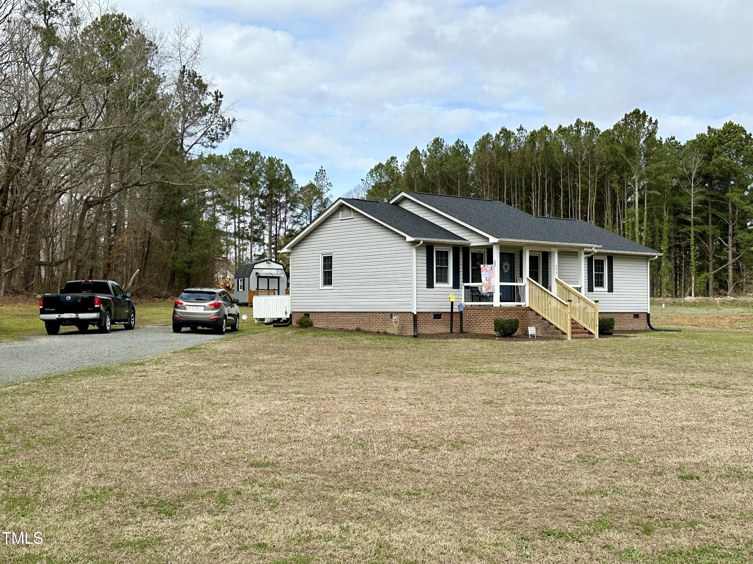 242 Edwards Road Henderson, NC 27537 - Photo 4 of 21 a view of a house with a patio