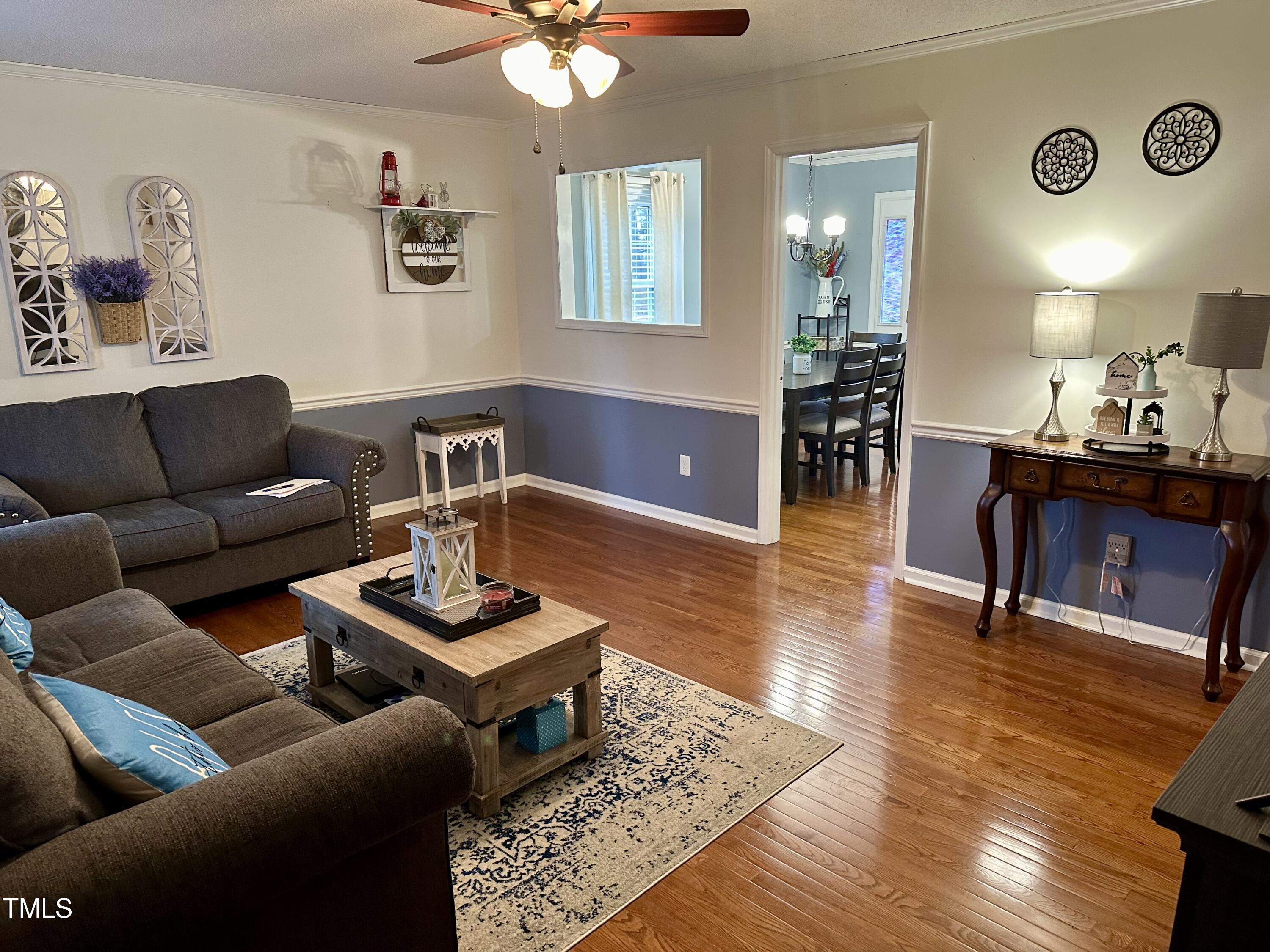 242 Edwards Road Henderson, NC 27537 - Photo 7 of 21 a living room with furniture and wooden floor