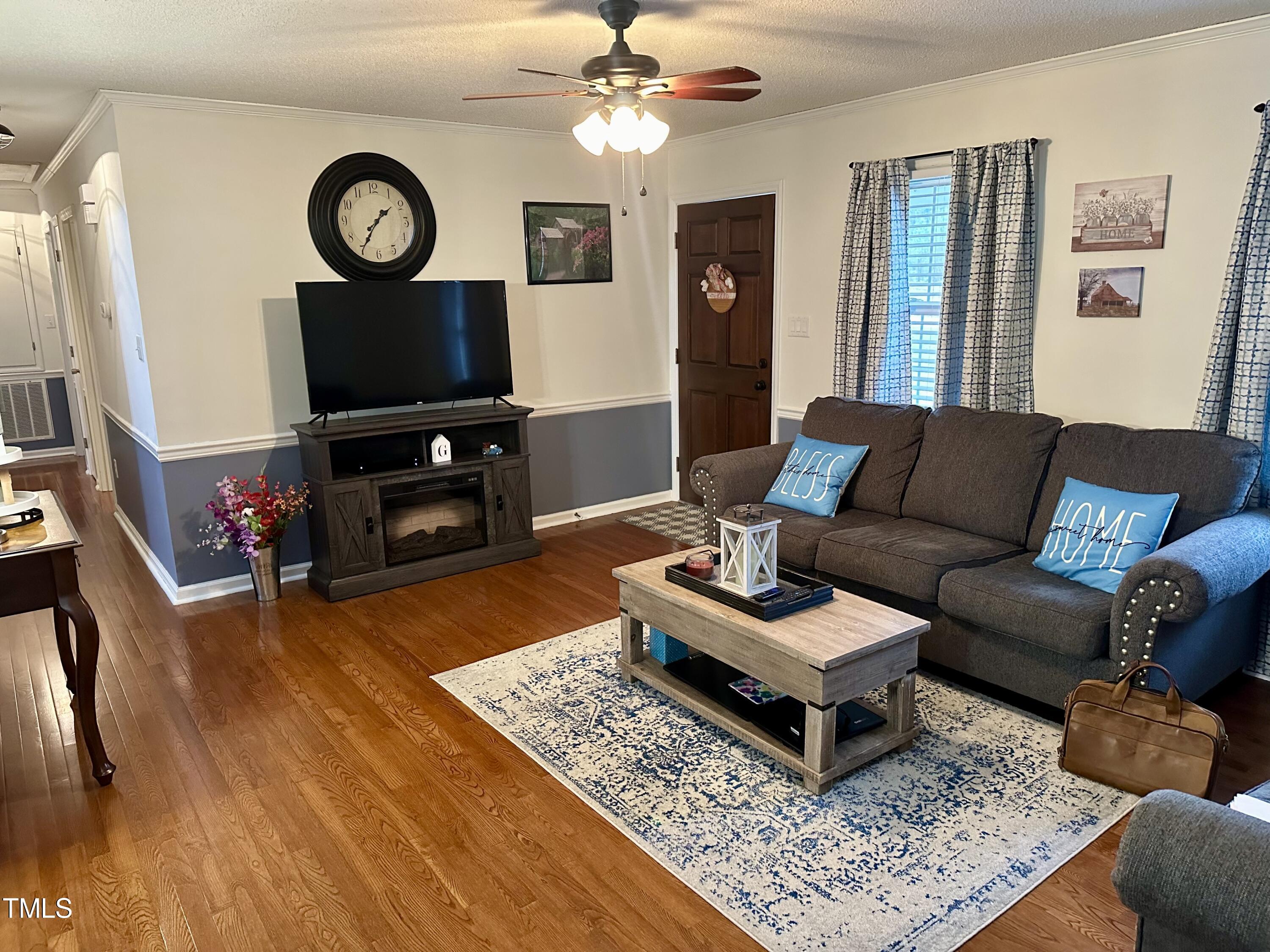 242 Edwards Road Henderson, NC 27537 - Photo 8 of 21 a living room with furniture and a flat screen tv